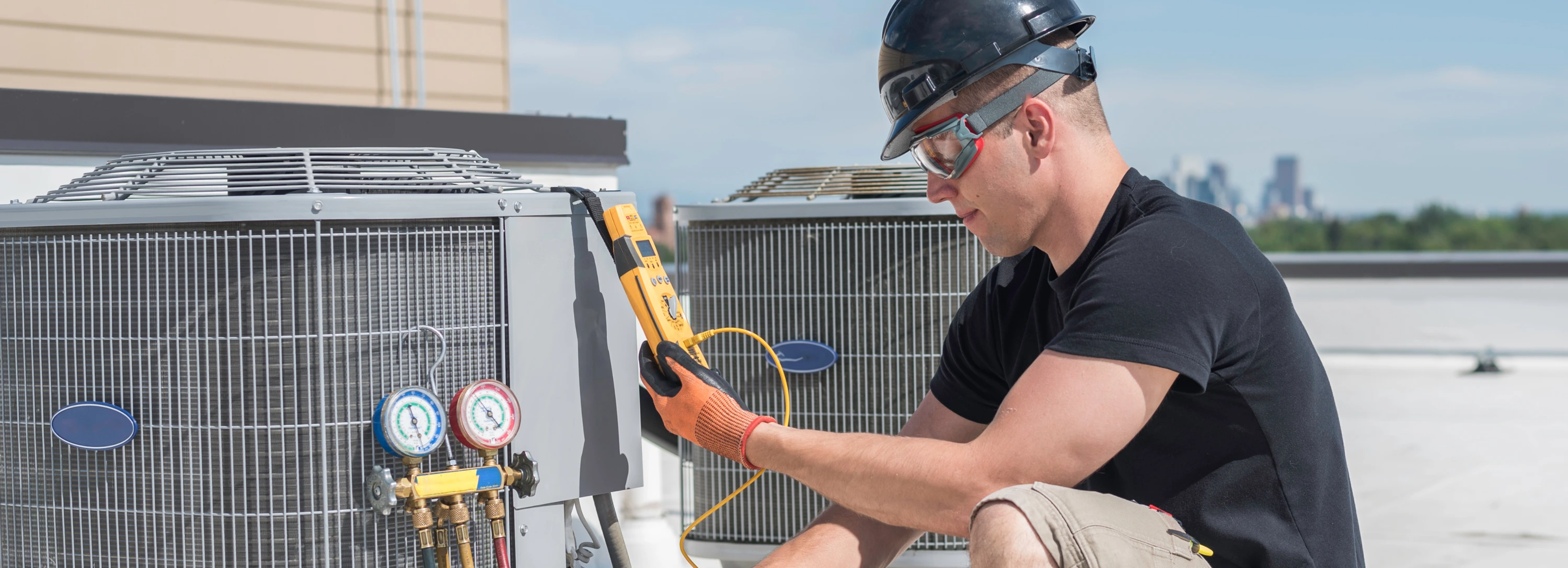 HVAC technician servicing a rooftop condensing unit